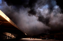 Two men walked through the grounds of a Iraqi government ministry as looters burnt buildings in the Iraqi capital